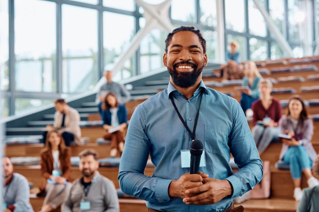 Happy Black Public Speaker During Business Confere 2024 12 13 18 31 21 Utc 1024x682