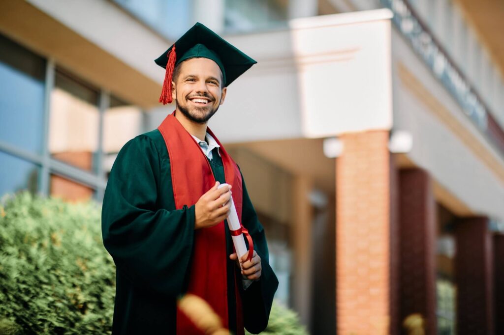 Happy University Student In Graduation Gown Holdin 2024 12 13 20 06 29 Utc 2 1024x682