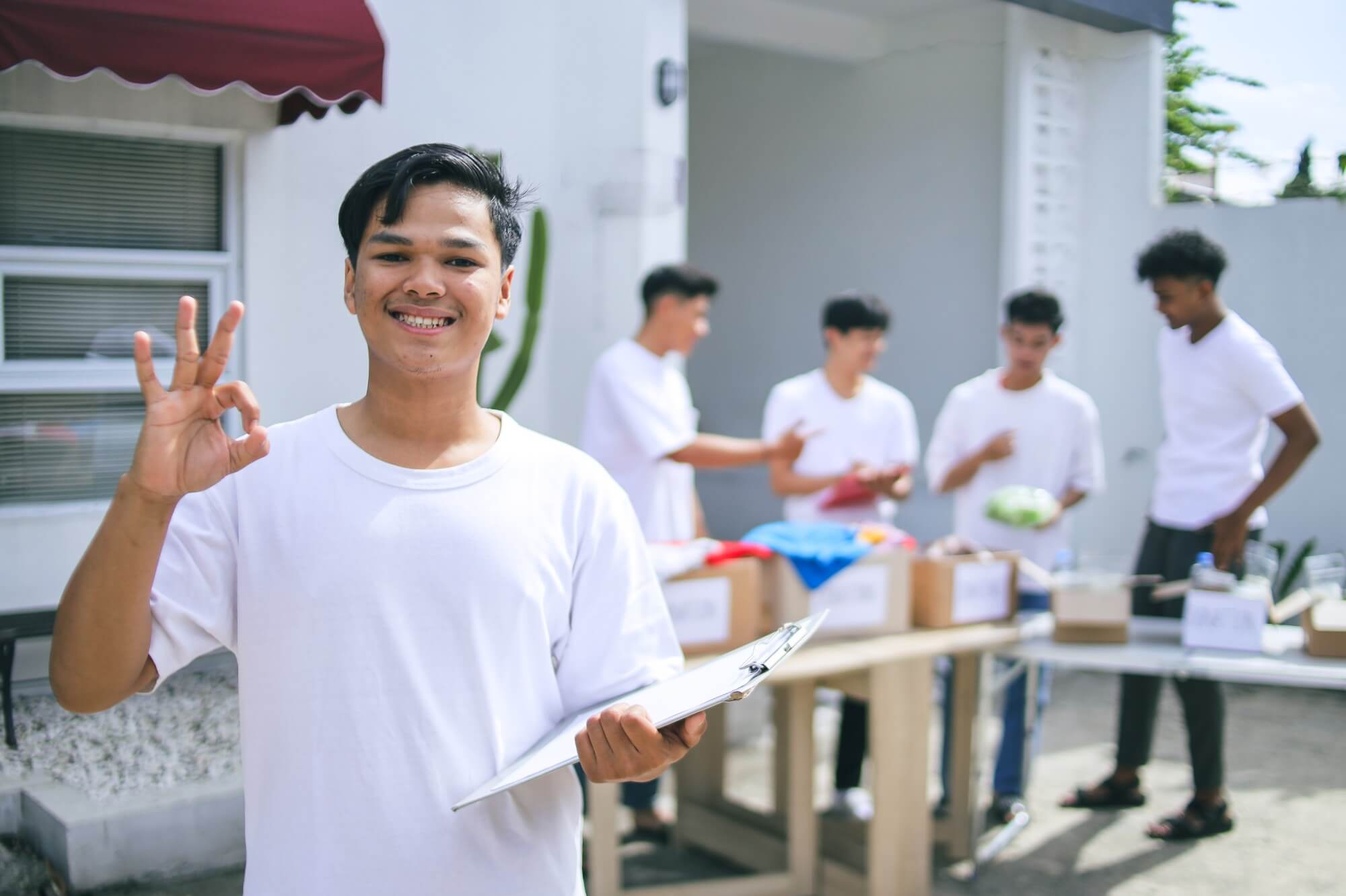 Smiling Young Asian Man Holding Document And Showi 2025 04 21 19 43 49 Utc